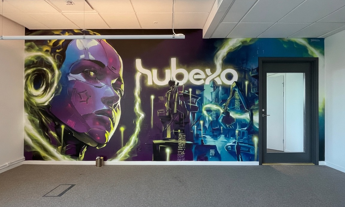 The same wall, painted with a colorful Spraya mural